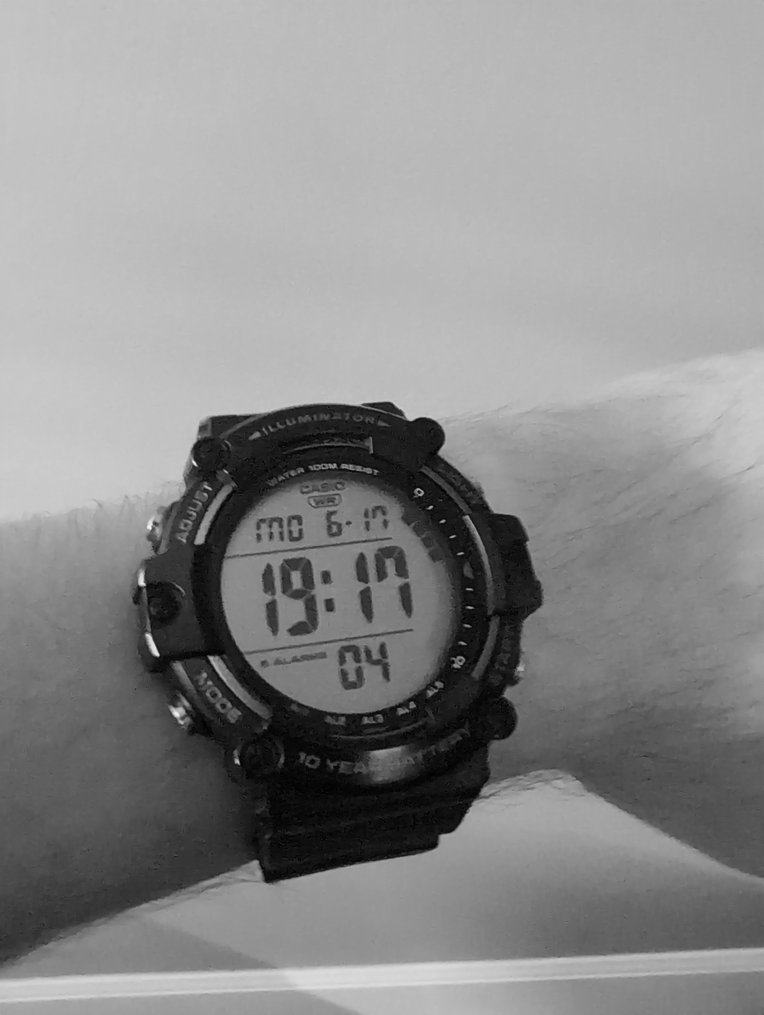 black and white photo of a casio watch on a wrist